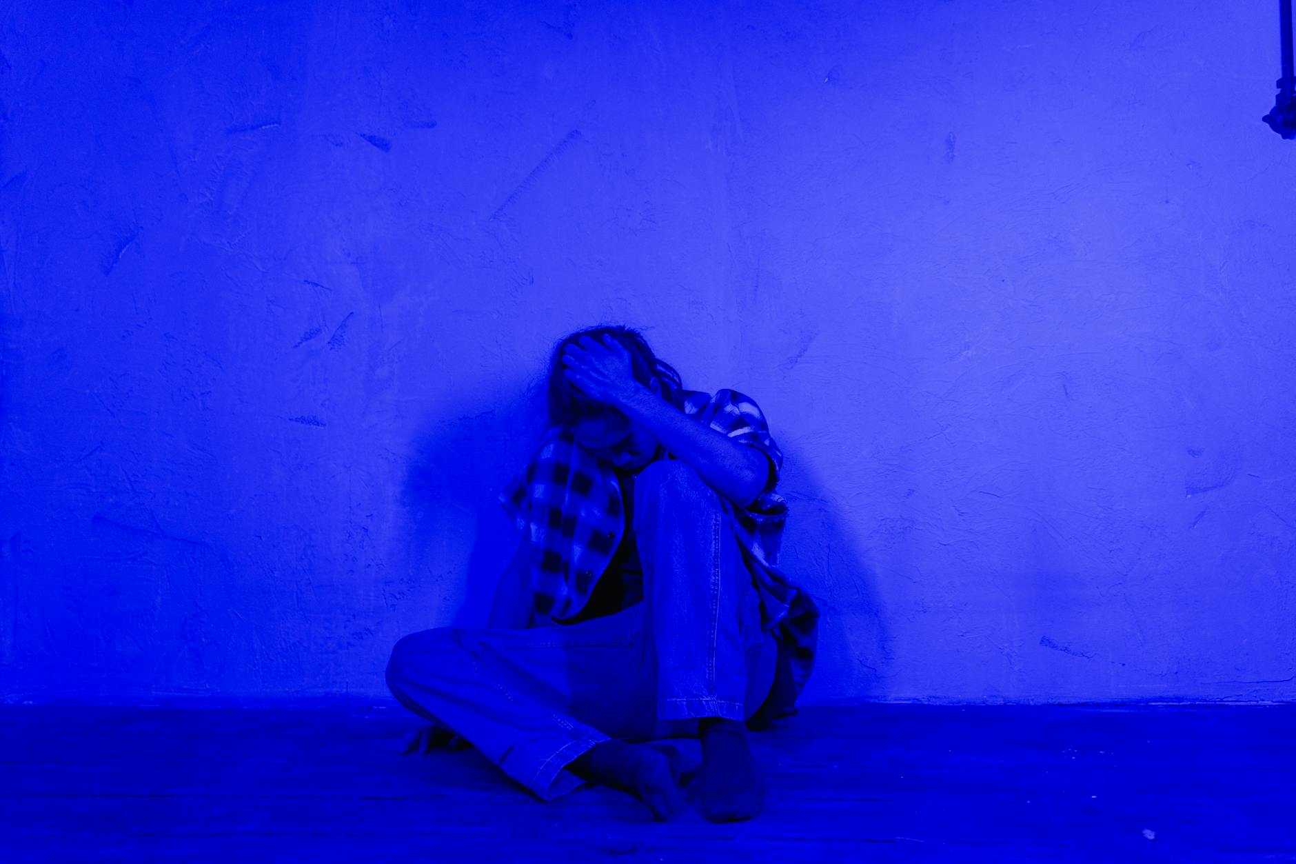 woman in black and white scarf sitting on floor